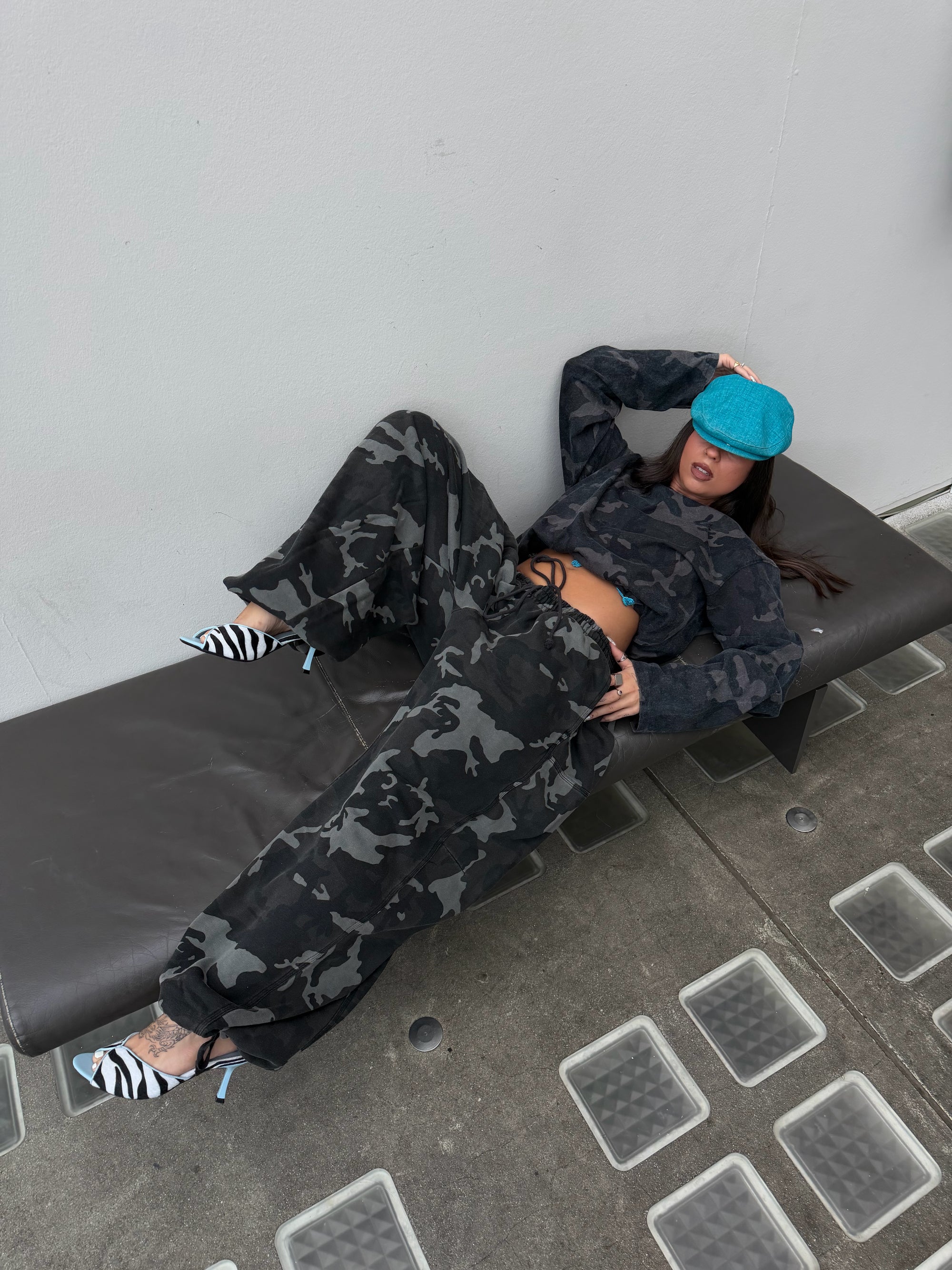 Matching Weekday camo long sleeve tee and oversized camo joggers.