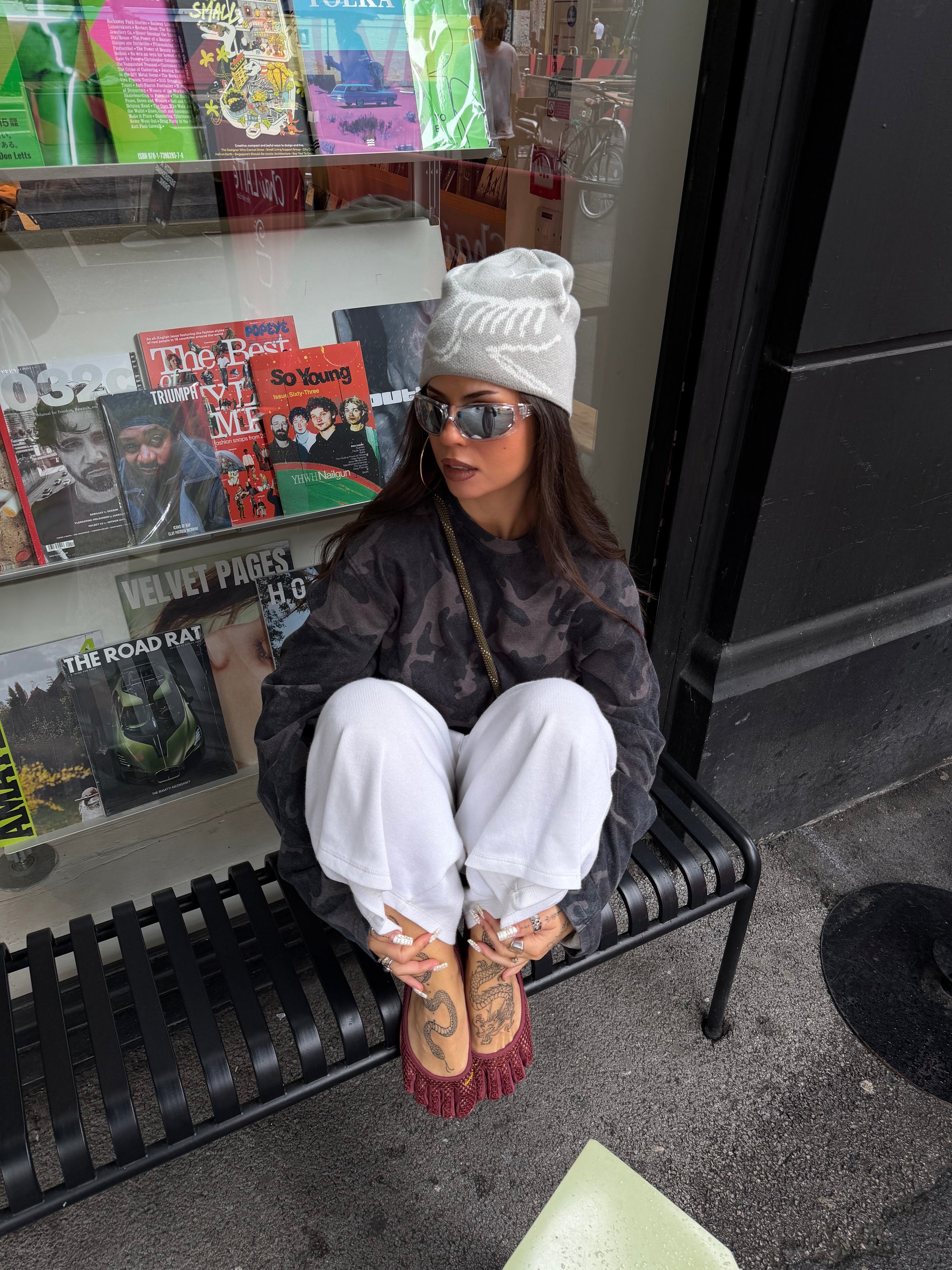 Weekday camo long sleeve top styled with oversized white jogger jorts.