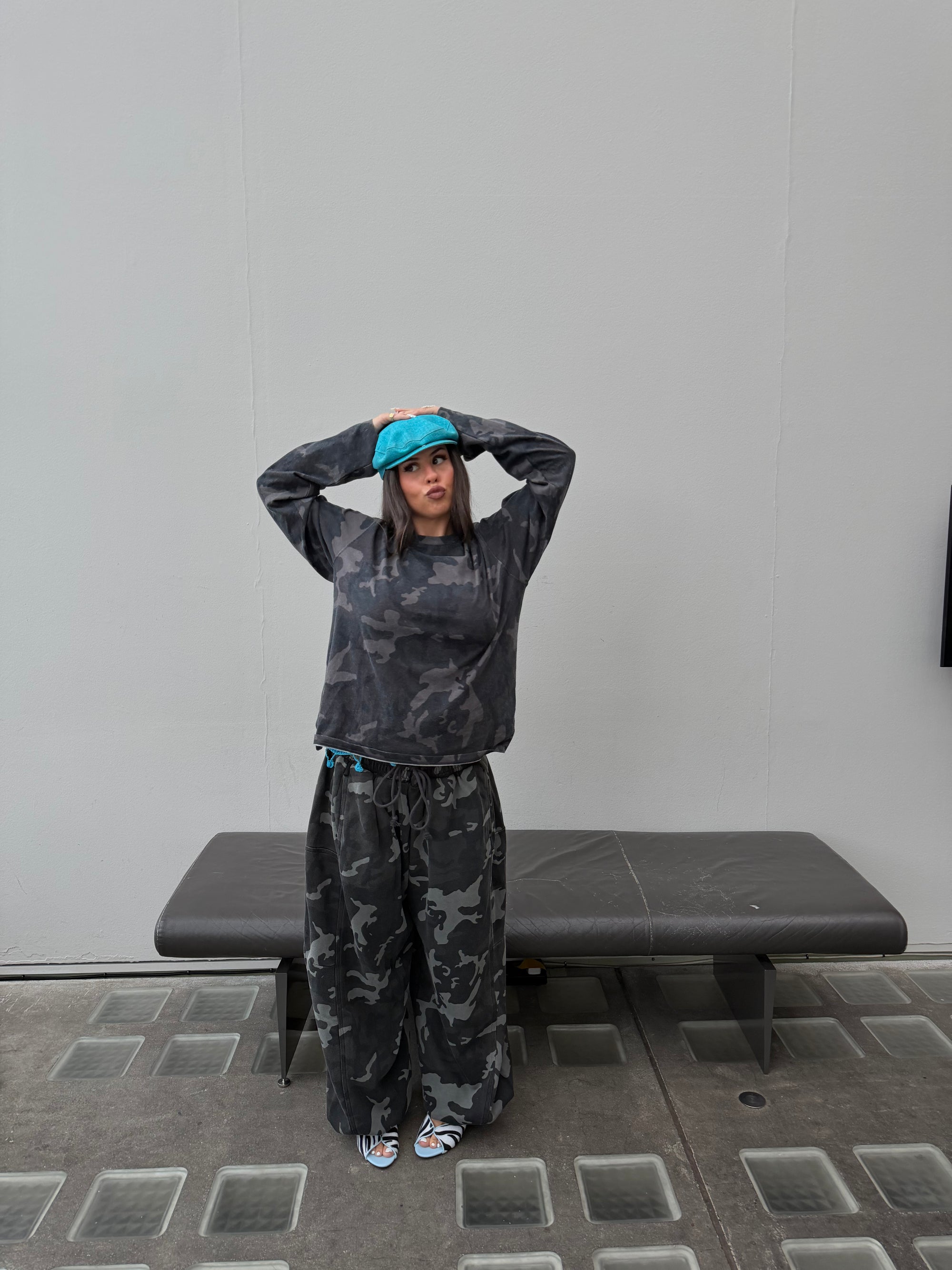 Matching Weekday camo long sleeve tee and oversized camo joggers.