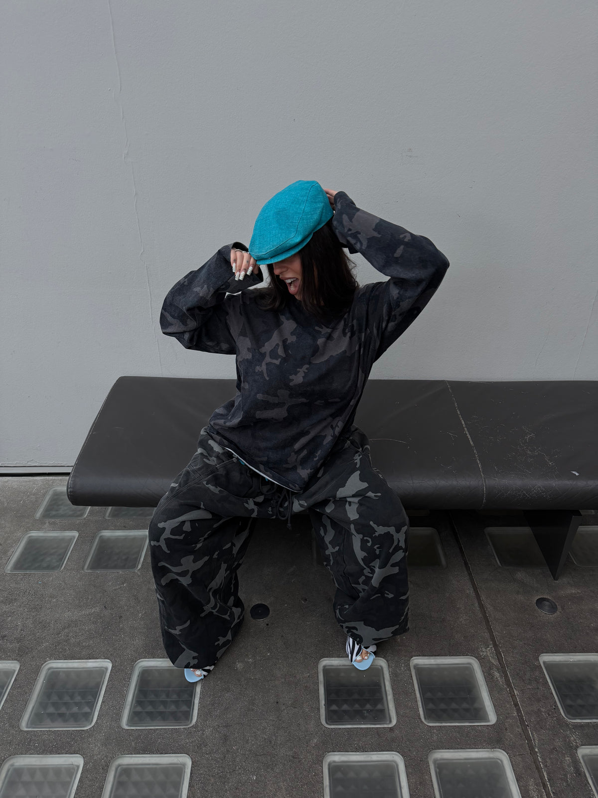 Matching Weekday camo long sleeve tee and oversized camo joggers.