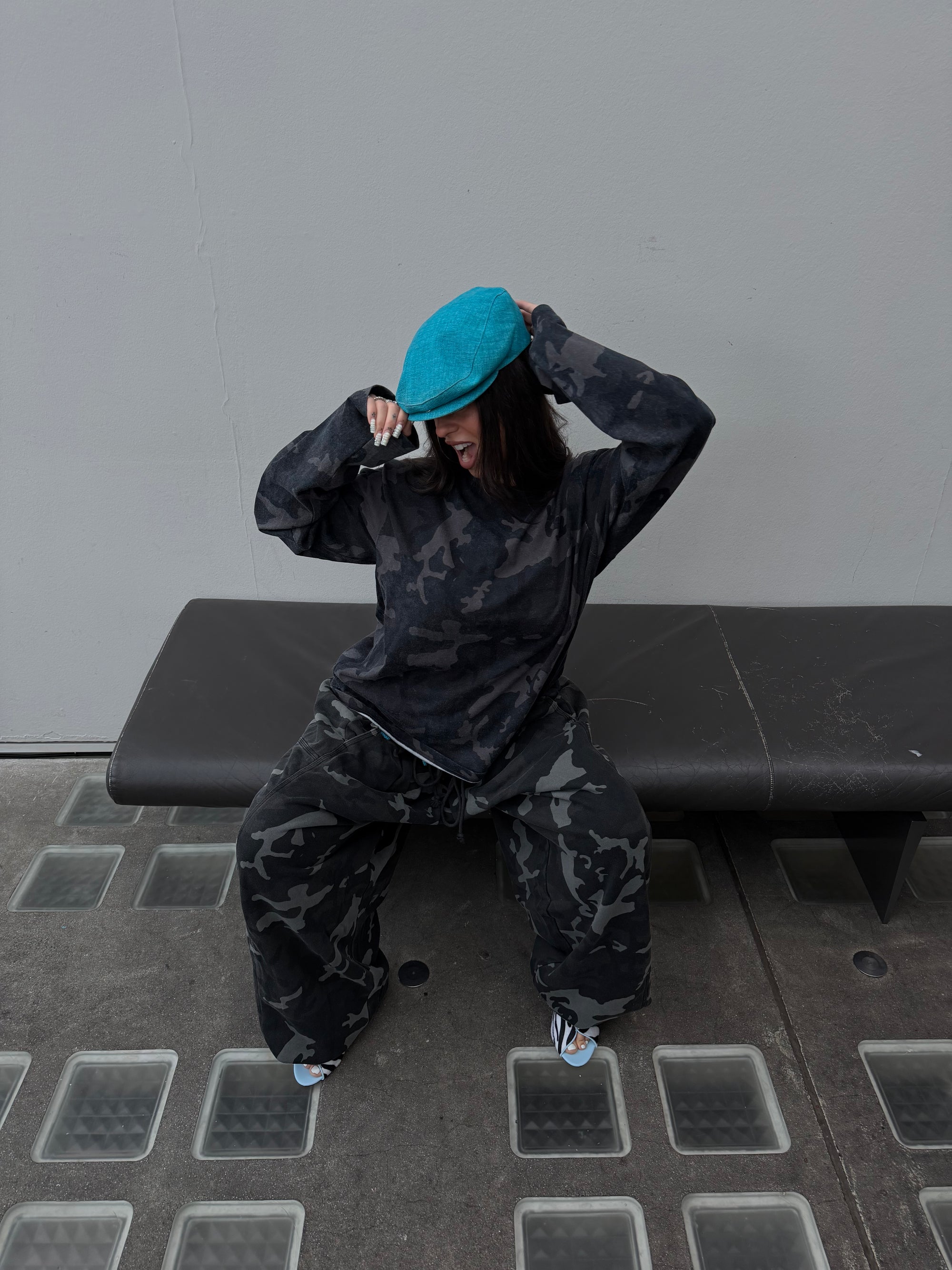 Matching Weekday camo long sleeve tee and oversized camo joggers.