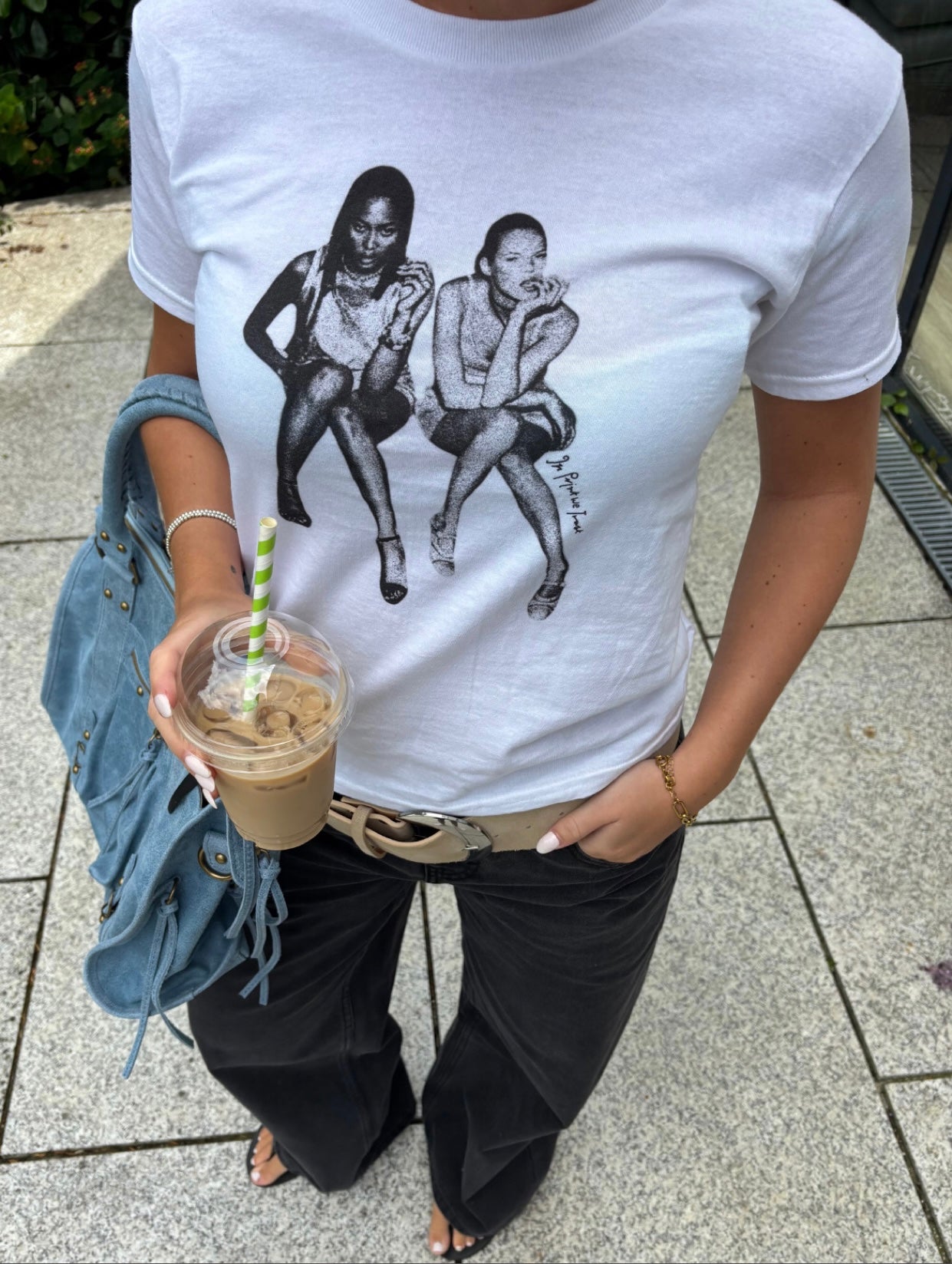 White In Print We Trust After Party Baby Tee styled with black Studio 54 jeans and a blue bag.