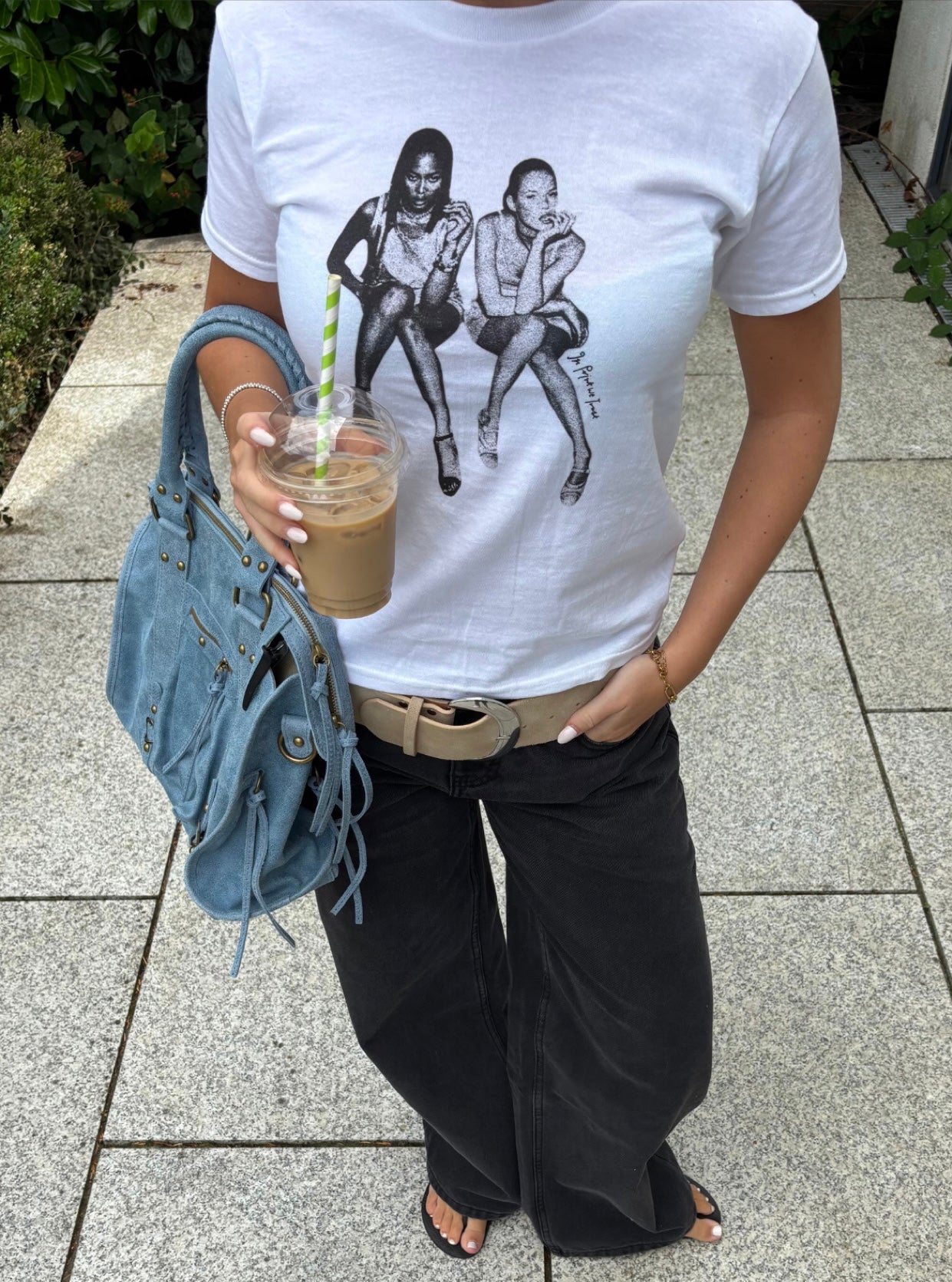 White In Print We Trust After Party Baby Tee styled with black Studio 54 jeans and a blue bag.