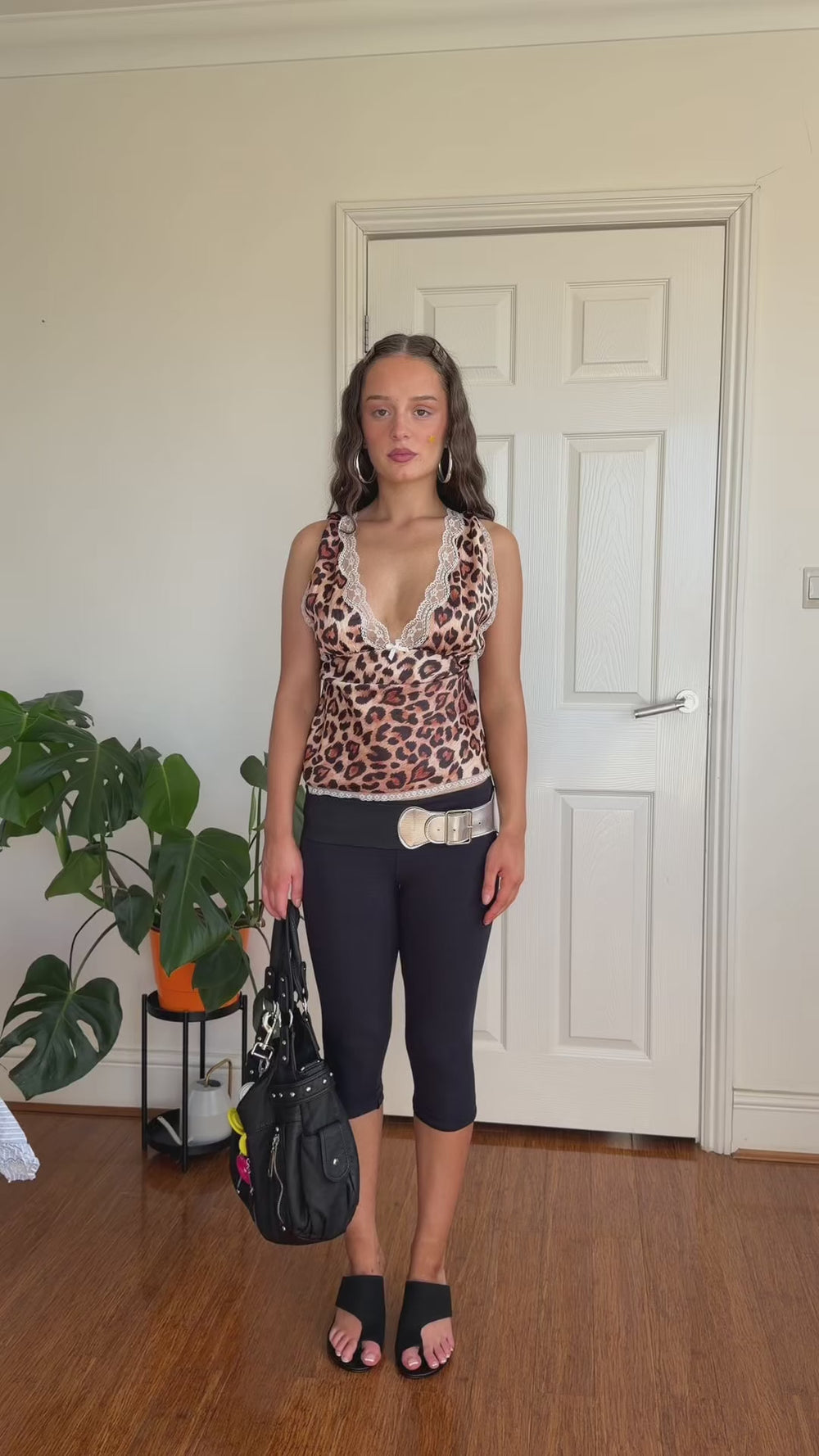 Leopard print lace-trim cami styled with oversized neutral shorts, black flats, glasses and a brown shoulder bag.